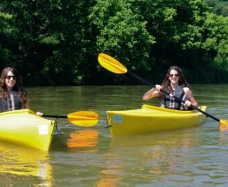 two sisters in yellow kayaks enjoying the calm waters Downriver Canoe Company Shenandoah Valley River