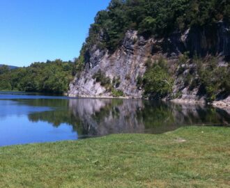 serene view of river and tent on enbankment Downriver Canoe Company Shenandoah Valley River