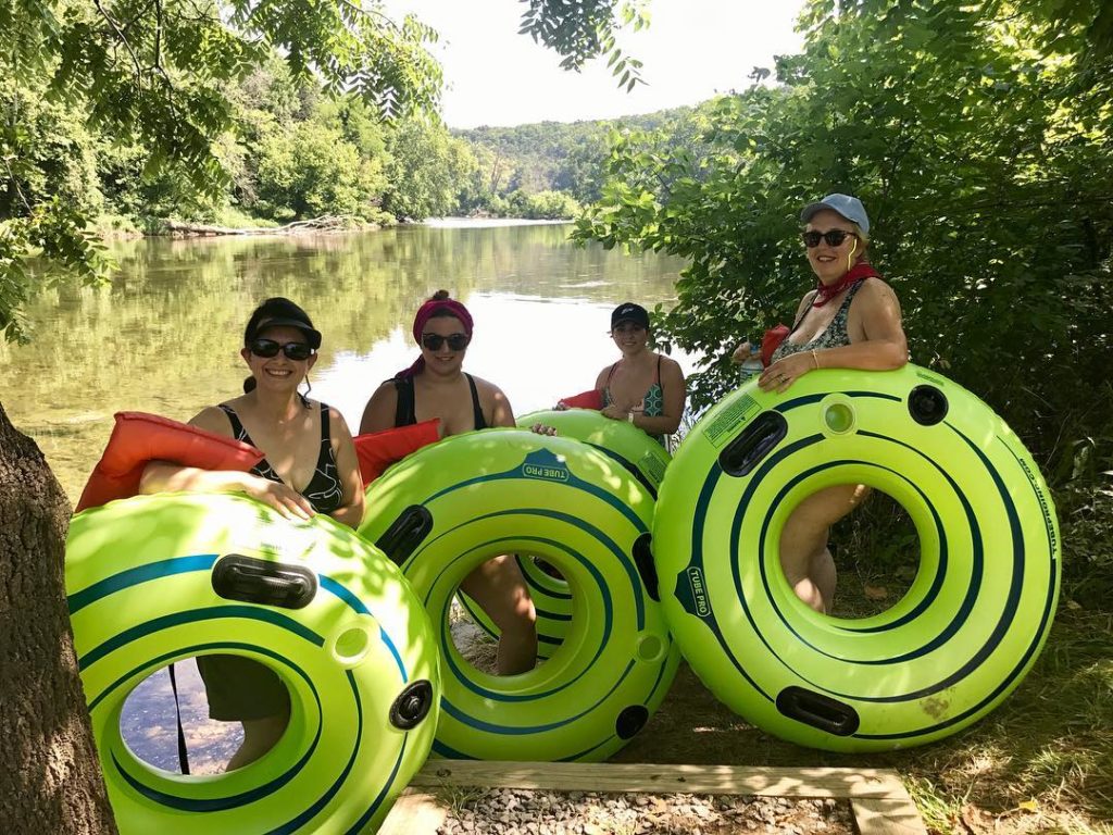 four women take a break in the shade during their tube adventure Downriver Canoe Company Shenandoah Valley River